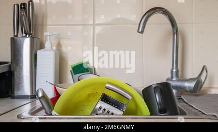 Les ustensiles de cuisine dans le lavabo doivent être lavés. Une pile de vaisselle sale dans l'évier de cuisine. Les ustensiles de cuisine doivent être lavés Banque D'Images