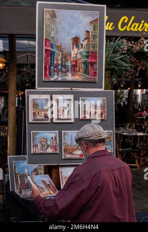 Peintre sur la place du Tertre avec peintures traditionnelles - Montmartre, Paris, France Banque D'Images
