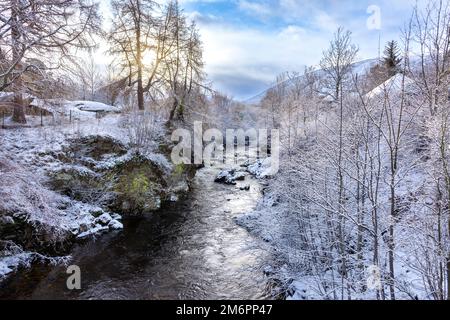 Braemar Ecosse recherche de l'eau de Clunie depuis le pont les rives de la rivière couvertes de neige en hiver Banque D'Images