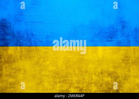 Le mur est aux couleurs du drapeau national ukrainien - bleu et jaune. Arrière-plan abstrait de texture de mur en pierre de béton. Banque D'Images