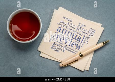 revue annuelle nuage de mot sur une serviette avec une tasse de thé, business concept Banque D'Images