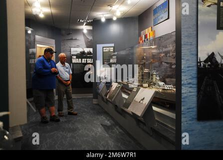 Gary Royse (à droite), un docien bénévole au Musée naval de Hampton Roads, pose des questions à un visiteur de leur galerie, vendredi, 6 mai 2022. Le musée, situé au deuxième étage du campus de Nauticus dans le centre-ville de Norfolk, en Virginie, abrite un solide corps de bénévoles qui aide le musée à relier les visiteurs à l'histoire navale de Hampton Roads, dans la région de Virginie. Banque D'Images