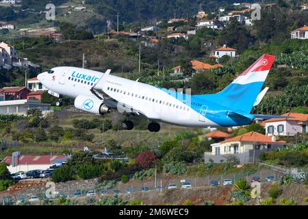 Décollage d'un avion Boeing 737 de la compagnie aérienne Luxair. Transporteur de pavillon Luxembourg Airlines (LUXAIR) avec B737 avions au départ de l'aéroport de Madère Funchal. Banque D'Images