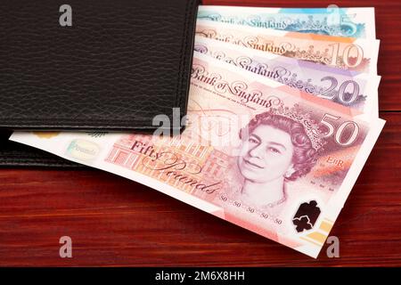 Livres anglais dans le portefeuille noir Banque D'Images