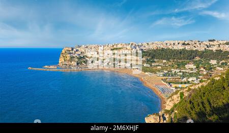 Summer sea perched Peschici beautiful town view, Gargano peninsula in Puglia, Italy. People are unrecognizable. Stock Photo