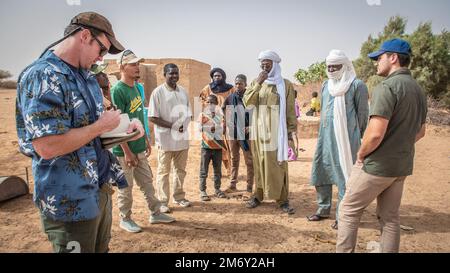 ÉTATS-UNIS Soldats de l’armée de terre de l’équipe des affaires civiles du groupe expéditionnaire aérien (AEG) de 409th, ainsi que deux soldats des forces armées nigériennes (langue française : Forces armées nigeriennes - FAN) équipe des affaires civiles, discuter de la stabilisation du village et de l'avancement d'un précédent projet de restauration de l'eau avec le chef du village et son chef adjoint à Alwat, Niger, 9 mai 2022. Ces réunions, facilitées par l'équipe des affaires civiles de l'AEG en 409th, renforcent le partenariat du FAN avec les villages locaux, ce qui permet d'établir de solides relations et de renforcer la continuité de l'engagement entre le gouvernement du Niger et son citi Banque D'Images