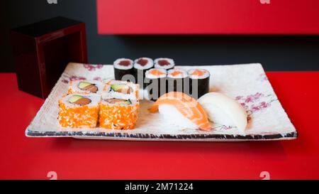 Ensemble de sushis avec une variété de makis, nigiris et sashimi avec des poissons fins comme le saumon et le thon. Banque D'Images