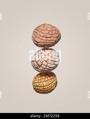 délicieux coquillages mexicains, pains artisanaux de trois saveurs, chocolat, sucre et vanille volant dans un fond minimaliste, pas de personnes Banque D'Images