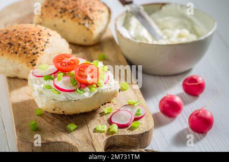 Sandwich maison et sain avec pain croquant, radis et fromage de fromage. Sandwich avec légumes et fromage pour le petit déjeuner. Banque D'Images