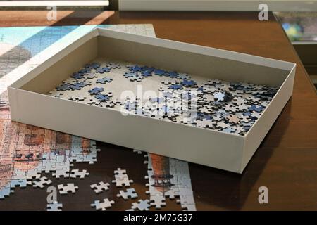 Boîte de pièces de puzzle sur une table Banque D'Images