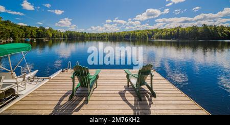 Deux chaises de l'Ontario assises sur un quai de chalet en bois Banque D'Images