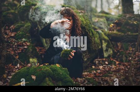 Femme shaman et encens dans ses mains, encens dans une main de femme, espace de cérémonie. Banque D'Images