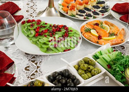 Repas de fête, salade de kiwi d'arbre de Noël et saucisses Banque D'Images