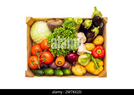 Légumes frais dans une boîte en bois isolée sur fond blanc. Mode de vie écologique Banque D'Images