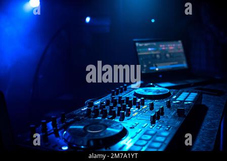 Contrôleur de musique DJ professionnel dans la discothèque sous le feu de l'actualité bleu Banque D'Images