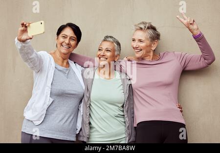 Téléphone selfie, femmes âgées et signe de paix fitness pour l'entraînement, la motivation d'entraînement ou le style de vie sportif heureux. Amis âgés, sourire et Banque D'Images