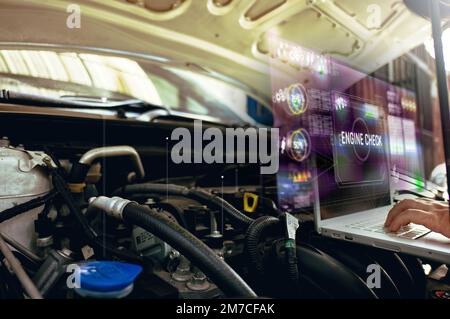 Homme utiliser ordinateur portable pour l'analyse sur son moteur de voiture avec hologramme. le concept de la communication, du réseau, de l'assurance de l'hologramme de service moteur Banque D'Images