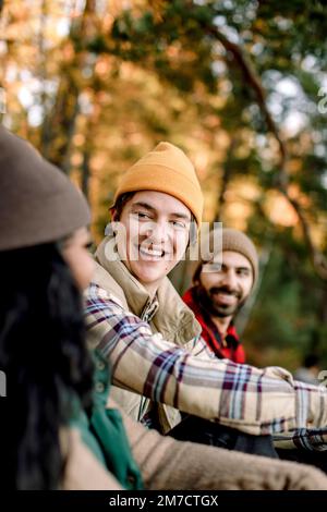 Joyeux homme en train de profiter pendant le camping avec des amis Banque D'Images