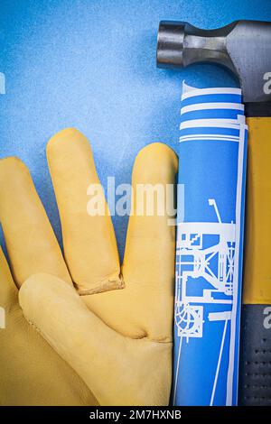 Composition de gants de sécurité pour marteau à griffe bleus sur fond bleu. Banque D'Images