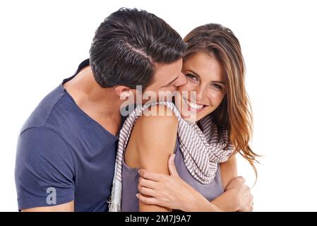 Vous êtes mon ange. Studio portrait d'un jeune homme embrassant sa petite amie sur la joue isolée sur blanc. Banque D'Images