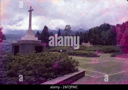 Le cimetière de guerre de Kohima est un monument dédié aux soldats de la division britannique des forces alliées de 2nd qui sont morts à Kohima pendant la Seconde Guerre mondiale. LE CIMETIÈRE DE GUERRE DE KOHIMA se trouve sur le terrain de bataille de Garrison Hill. Il ne reste aucune trace du bungalow, qui a été détruit dans les combats, mais des lignes de béton blanc marquent et préservent en permanence le court de tennis historique. Le cimetière contient maintenant 1 420 sépultures du Commonwealth de la Seconde Guerre mondiale et 1 sépultures hors guerre. Banque D'Images