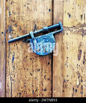 Cadenas en fer forgé sur une porte en bois dans le village de Cefalu, Sicile Banque D'Images