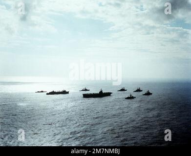 Vue à tribord du porte-avions USS INDEPENDENCE (CV-62) et de son groupe de combat qui rentrent du déploiement en mer Méditerranée. Les navires incluent, dans le sens des aiguilles d'une montre, de droite à droite : Le destroyer de missile guidé USS FARRAGUT (DDG-37), la frégate USS MCCANDLESS (FF-1084), l'INDÉPENDANCE, le navire de soutien de combat rapide USS DETROIT (AOE-4), la frégate USS GARCIA (FF-1040), le destroyer de missile guidé MAHAN (DDG-42), le destroyer USS CARON (DD-970) et le DESTROYER (DD PETERSON (DD-969). Pays: Océan Atlantique (AOC) Banque D'Images