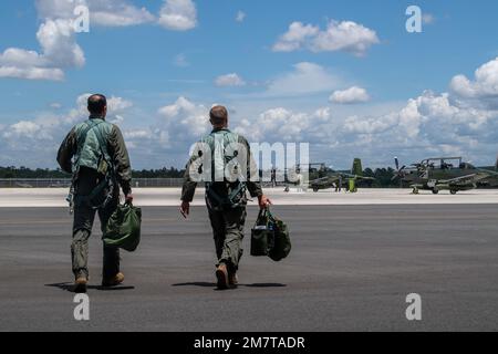 ÉTATS-UNIS Le lieutenant-colonel Matthew Hall de la Force aérienne, instructeur PILOTE AT-6E Wolverine, à droite, et le capitaine de la Force aérienne tunisienne Jihed Makni, pilote, marchent jusqu'à un AT-6E au champ de répartition de la Force aérienne du parc Avon, Floride, 12 mai 2022. États-Unis La Force aérienne a établi un partenariat avec la Colombie, la Tunisie, le Nigeria et la Thaïlande pour développer conjointement des tactiques, des techniques et des procédures de lutte contre les organisations extrémistes violentes tout en démontrant les capacités du réseau aérien de relais extensible sur horizon. Banque D'Images