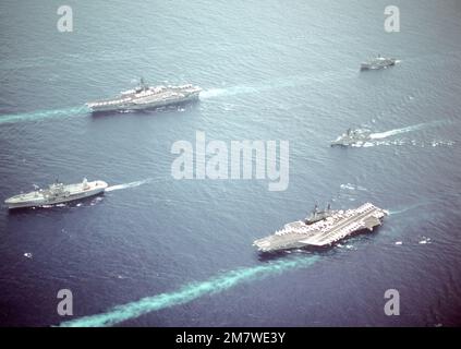 Vue aérienne du port d'une partie du Groupe de travail 70 en cours. Les navires du groupe de travail sont : (dans le sens des aiguilles d'une montre à partir du navire de tête) le navire de commandement amphibie USS BLUE RIDGE (LCC-19), le porte-avions USS RANGER (CV-61), le magasin de combat USS SAN JOSE (AFS-7), le destroyer de missile guidé USS JOSEPH STRAUSS (DDG-16) et le porte-avions USS MIDWAY (CV-41). Pays: Mer des Philippines Banque D'Images