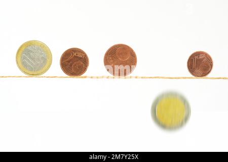 Pièces d'euros en équilibre sur une corde mince, on tombe, crise financière, inflation, danger de pauvreté concept. Banque D'Images