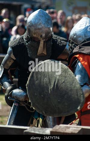 Les restaurateurs médiévaux se battent avec des épées en armure lors d'un tournoi de chevaliers, restauration historique des combats de chevaliers Banque D'Images