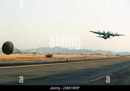 Un avion Hercules C-130 du Commandement du transport aérien militaire (MAC) dépose une palette de fournitures à l'aide du système d'extraction de parachute à basse altitude (LAPES) lors de l'ÉQUIPE d'exercice conjointe États-Unis/Sud Koren SPIRIT '84. Objet opération/série: TEAM SPIRIT '84 base: Osan Air base pays: République de Corée (KOR) Banque D'Images