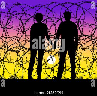 Un couple tient les mains et regarde le coucher du soleil à travers une clôture en fil de rasoir à la frontière des États-Unis et du Mexique. Ils ne peuvent pas croiser, regarder seulement à travers le fil de rasoir Banque D'Images