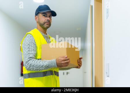 Un livreur dans un uniforme de protection lors de la livraison de commande en ligne Banque D'Images