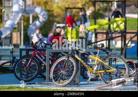 Dobele, Lettonie - 7 octobre 2022: Vélos pour enfants dans un parc près d'une aire de jeux publique Banque D'Images