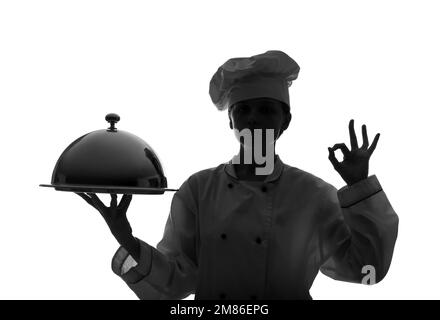 Silhouette de chef féminin avec cloche montrant un geste OK sur fond blanc Banque D'Images