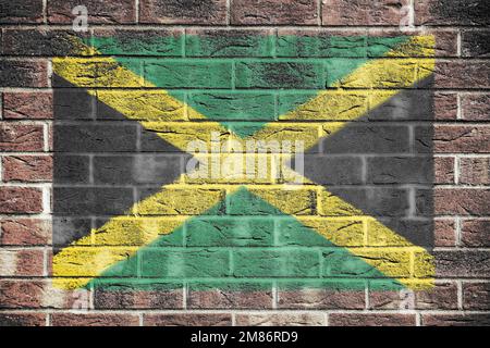 Drapeau jamaïcain peint sur fond de mur de briques Banque D'Images