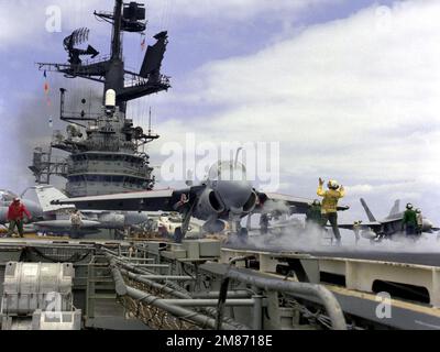 Un membre de l'équipage du pont de vol signale au pilote d'un avion Intruder A-6E alors que l'avion est prêt à être lancé à partir du porte-avions USS CORAL SEA (CV-43). Pays : inconnu Banque D'Images