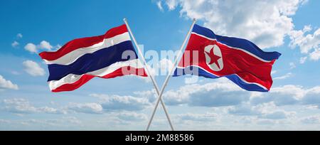 Deux drapeaux croisés la Corée du Nord et la Thaïlande agitant sous le vent à ciel nuageux. Concept de relation, de dialogue, de voyage entre deux pays. 3d illustration Banque D'Images