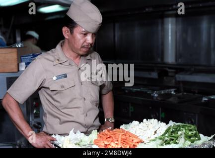 Un chef de la petite section vérifie un plateau de nourriture dans une allée à bord du porte-avions USS JOHN F. KENNEDY (CV 67). Pays: Océan Atlantique (AOC) Banque D'Images