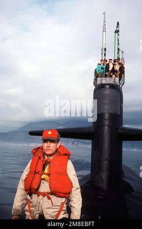 Owen C. Martin, maître de scout de la troupe scout 85, se tient sur le pont du sous-marin d'attaque nucléaire USS PHILADELPHIA (SSN 690) comme son scouts homme la voile avec le CMDR Ryan, commandant du navire. La troupe a été à bord du navire pour un séjour de 36 heures organisé par le commandant de la Sixième flotte. Base: Gaeta pays: Italie(ITA) Banque D'Images