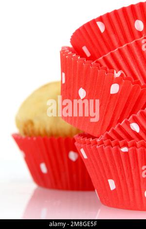 Moules à muffins et muffins sur fond blanc Banque D'Images