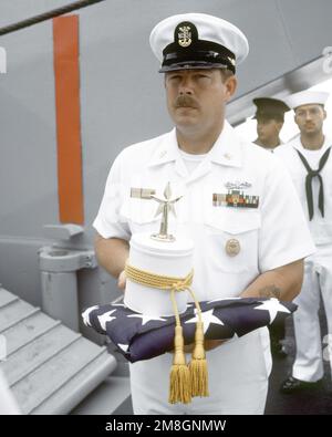 Le MCPO Charles Cartwright détient l'urne contenant les restes du CDR Harold Schwartz lors de l'enterrement en mer à bord du navire-citerne d'atterrissage RACINE (LST-1191), ancré au large du canal Guadalencanal dans les îles Salomon. Schwartz a été médecin affecté au bataillon de parachutistes de LA 1st Division Marine et a participé à des opérations de combat sur Guadalcanal, les îles Gilbert, les îles Marshall et Okinawa pendant la Seconde Guerre mondiale Pays : Océan Pacifique (POC) Banque D'Images