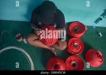 Malang, East Java, Indonésie. 13th janvier 2023. Les artisans font des lanternes rouges en préparation de la fête du nouvel an chinois. Les ventes de ces lanternes ont augmenté depuis deux mois, avec une vente moyenne de 6 000 unités. En plus d'être vendus dans des régions d'Indonésie, ces lanternes sont également exportées vers l'Italie, autour de 3 000 unités. (Credit image: © Moch Farabi Wardana/Pacific Press via ZUMA Press Wire) USAGE ÉDITORIAL SEULEMENT! Non destiné À un usage commercial ! Crédit : ZUMA Press, Inc./Alay Live News Banque D'Images