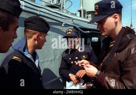 Midshipman 1st classe Michael Nelms, centre, sert d'interprète entre un membre de l'équipage de l'USS DEYO (DD-989) et des marins russes qui visitent le destroyer pendant l'exercice BALTOPS '93. Pour la première fois depuis 22 ans, les pays d'Europe orientale, à savoir l'Estonie, la Lettonie, la Lituanie, la Pologne et la Russie, ont été invités à participer aux phases non militaires de l'exercice. Sujet opération/série: BALTOPS '93 pays: Mer Baltique Banque D'Images