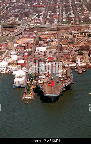 Un arc aérien en vue du porte-avions À propulsion nucléaire JOHN C. SENNIS (CVN-74) à l'embarcadère des installations de Newport News Shipbuilding et de Drydock Corporation sur la rivière James. Les chariots orange sur le pont sont des lits d'essai catapulte et sont tirés d'essai des catapultes pour simuler le poids de l'avion. Base: Newport News État: Virginie (va) pays: Etats-Unis d'Amérique (USA) Banque D'Images