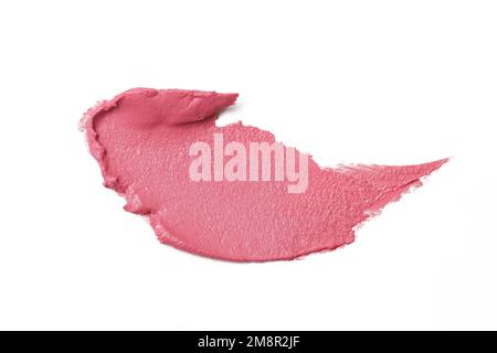 Un échantillon de maquillage à la céamie rose se lisait sur fond blanc. Frottis cosmétique décoratif. Banque D'Images