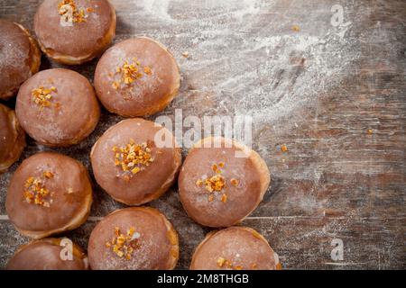 Gros jeudi. Photos de beignets avec garniture de cerise et glaçage. Beignets disposés sur un fond rustique. Banque D'Images