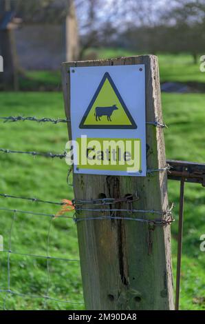 Lincolnshire, Angleterre Royaume-Uni - Un panneau d'avertissement pour les bovins sur un portier sur un sentier de campagne Banque D'Images