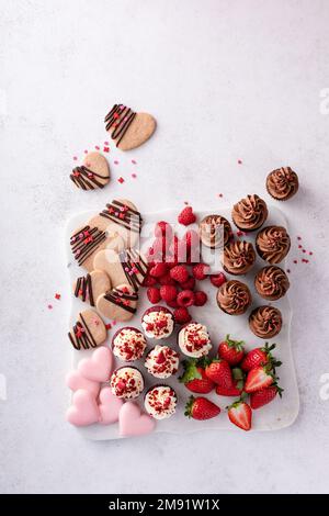 Plateau de charcuterie Saint-Valentin avec petits gâteaux et fraises Banque D'Images